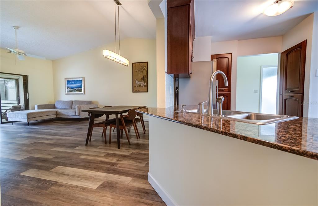 600 Carriage House Lane, Unit 201 Nokomis, FL 34275 - Photo 5 of 23 a living room with furniture a dining table chairs and a chandelier