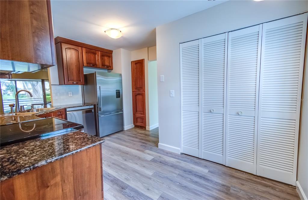 600 Carriage House Lane, Unit 201 Nokomis, FL 34275 - Photo 7 of 23 a kitchen with stainless steel appliances granite countertop a refrigerator and a sink