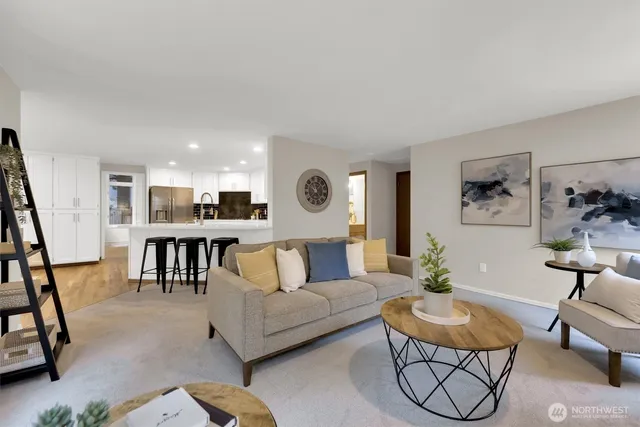 a living room with furniture and a dining table with wooden floor