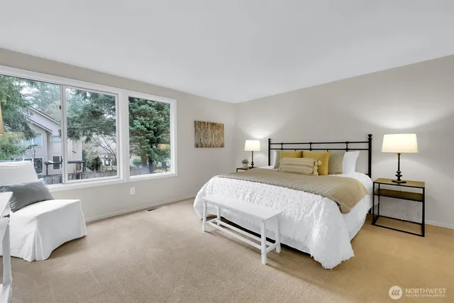 a bedroom with a bed and a large window