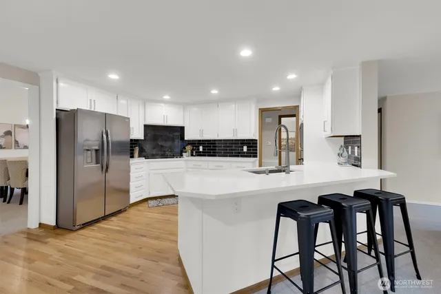 a kitchen with stainless steel appliances a refrigerator and a microwave