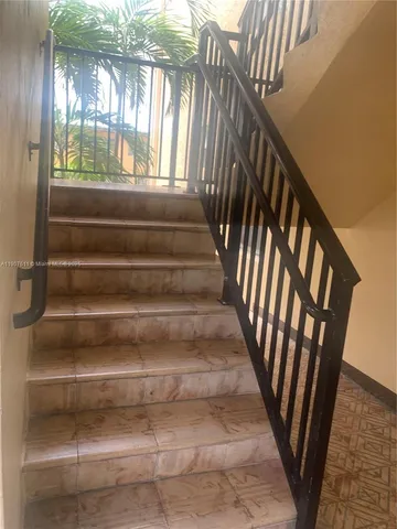 a view of hallway with furniture and a fireplace