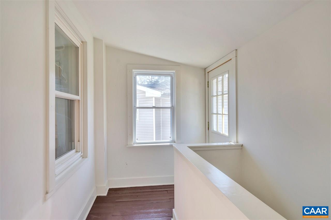 229 Shamrock Road Charlottesville, VA 22903 - Photo 11 of 23 a view of an empty room with wooden floor and a window