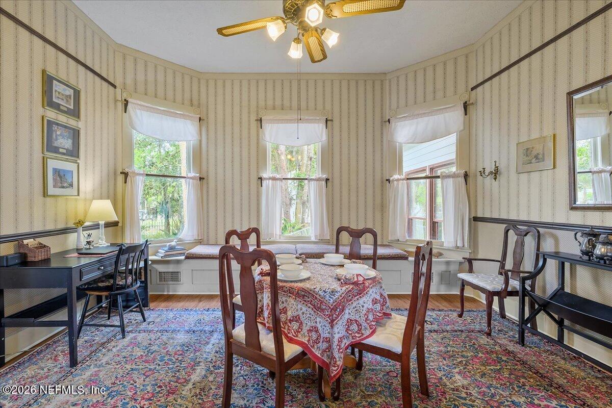 223 Madison Street Palatka, FL 32177 - Photo 11 of 60 a dining room with furniture a chandelier and wooden floor