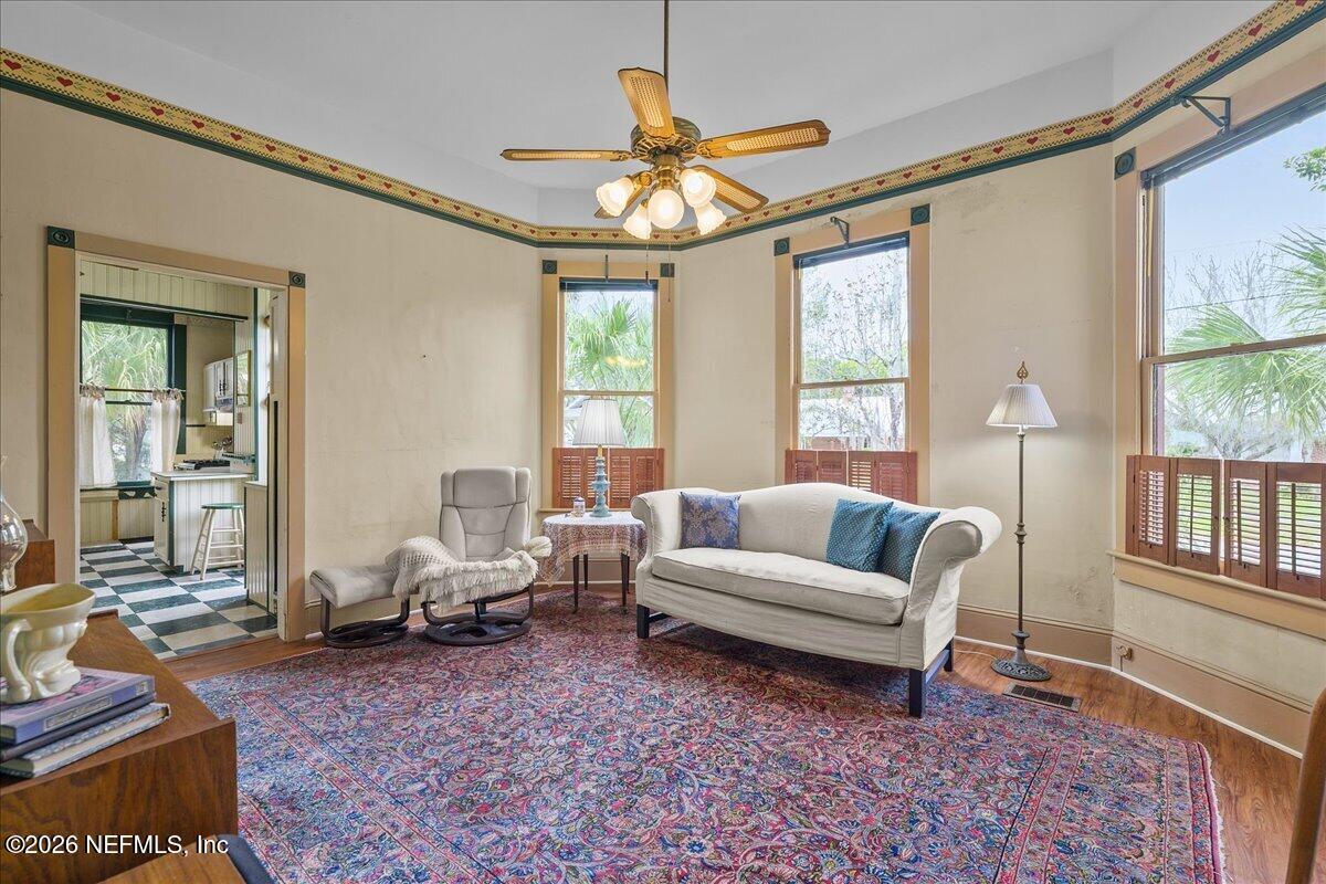 223 Madison Street Palatka, FL 32177 - Photo 12 of 60 a living room with furniture a chandelier and a rug