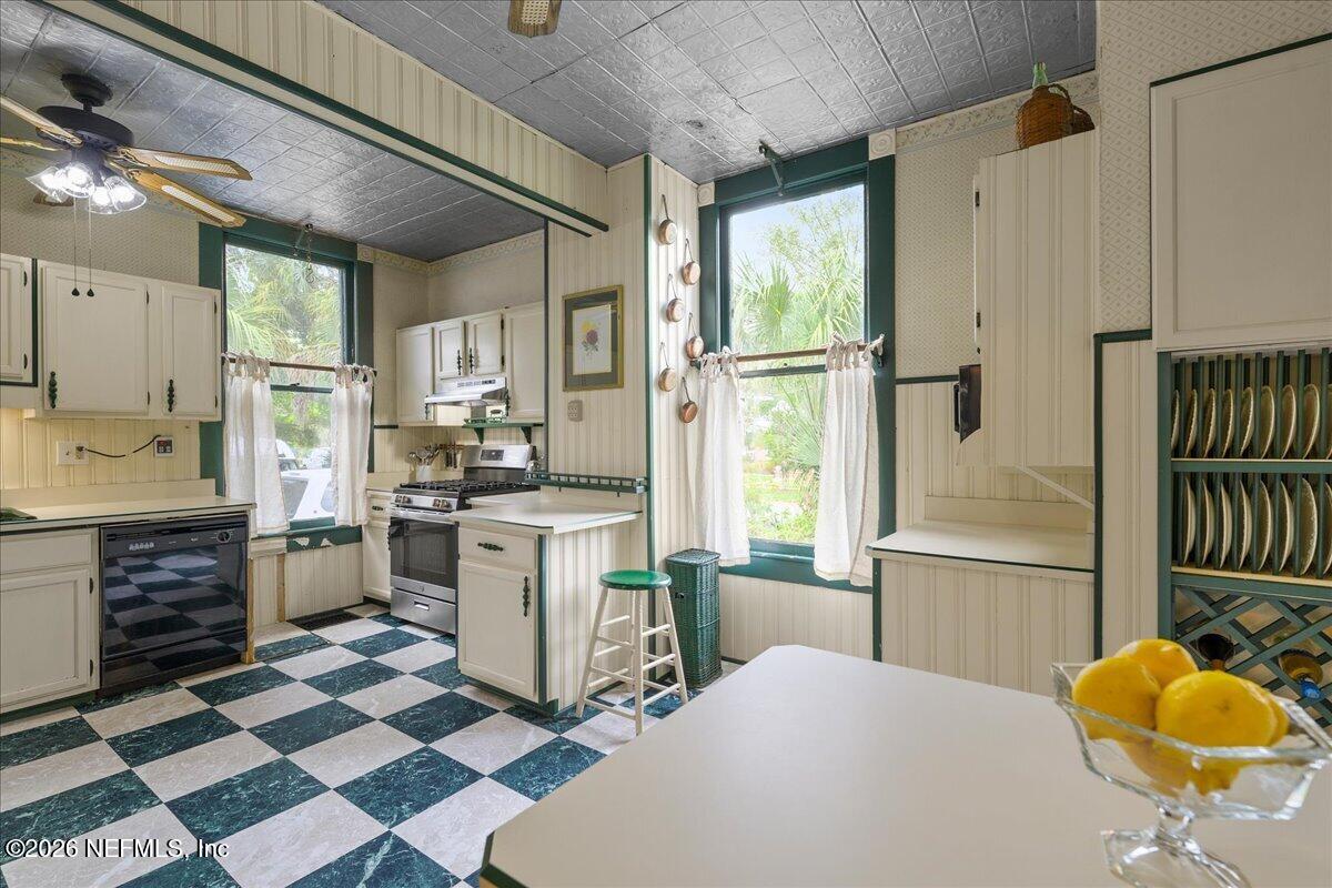 223 Madison Street Palatka, FL 32177 - Photo 16 of 60 a kitchen with a refrigerator a sink and cabinets