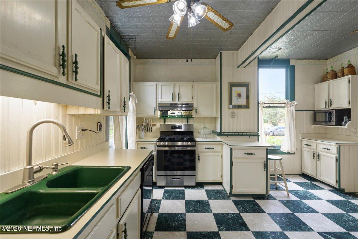 223 Madison Street Palatka, FL 32177 - Photo 19 of 60 a kitchen with a stove a sink and a refrigerator