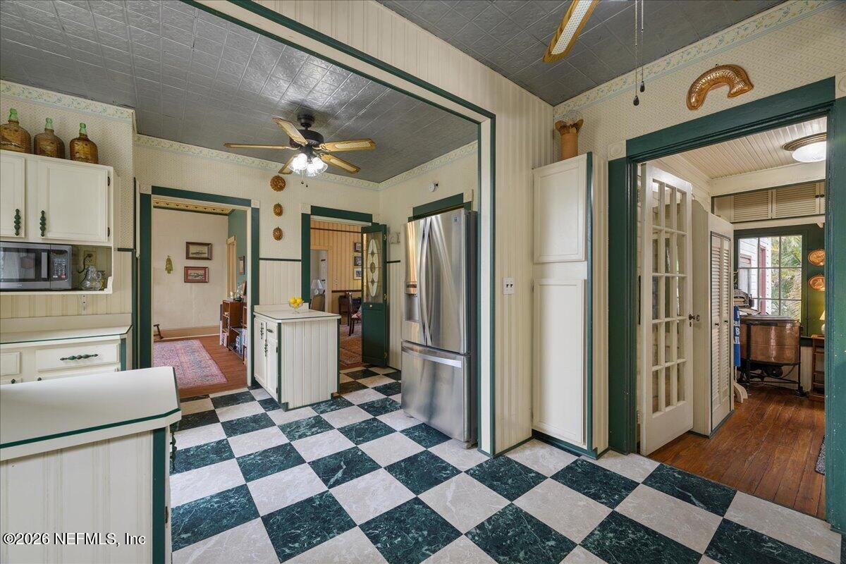 223 Madison Street Palatka, FL 32177 - Photo 20 of 60 a living room with a black white checkered floor with couches chair and a coffee table