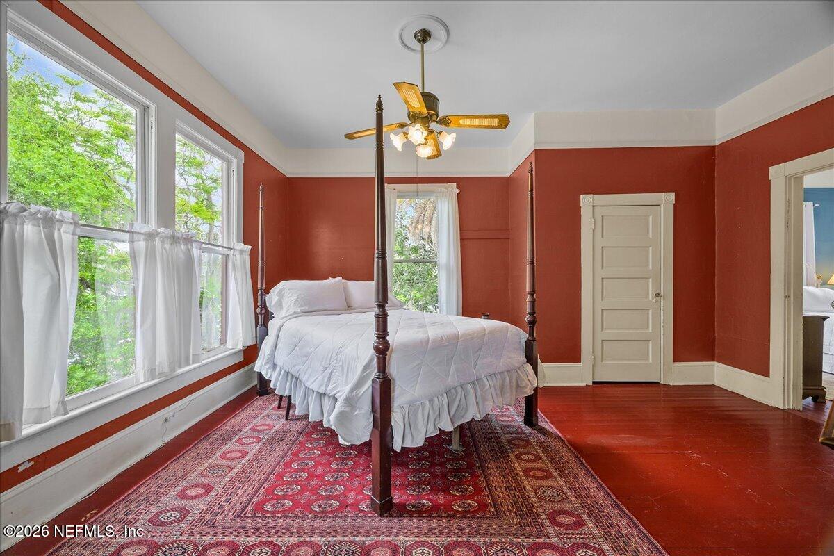 223 Madison Street Palatka, FL 32177 - Photo 25 of 60 a bed sitting in a bedroom next to a window