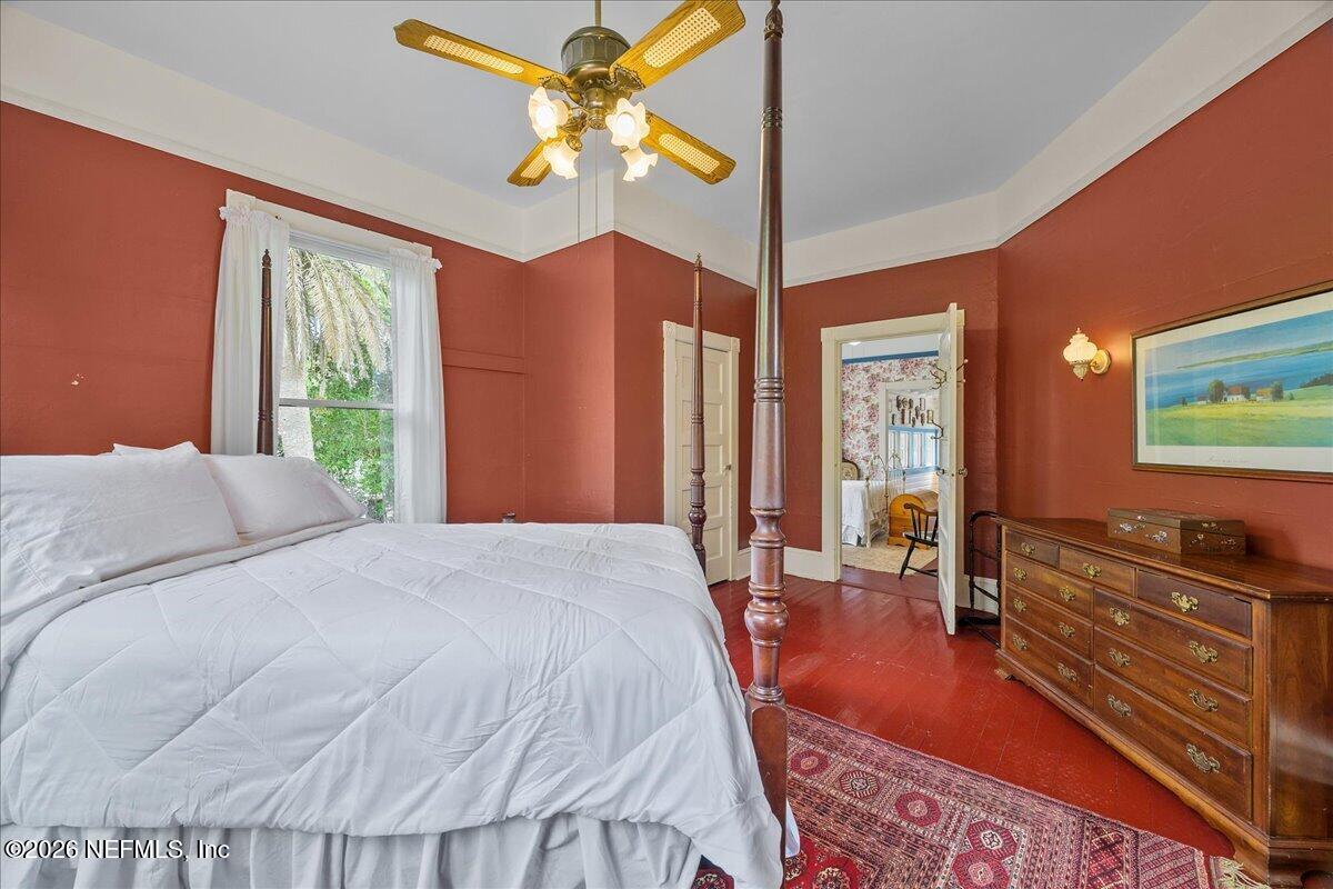 223 Madison Street Palatka, FL 32177 - Photo 26 of 60 a bedroom with a bed and dresser with mirror