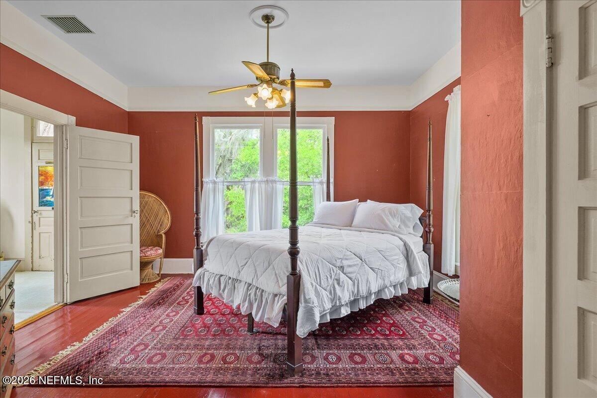 223 Madison Street Palatka, FL 32177 - Photo 27 of 60 a bed sitting in a bedroom next to a window