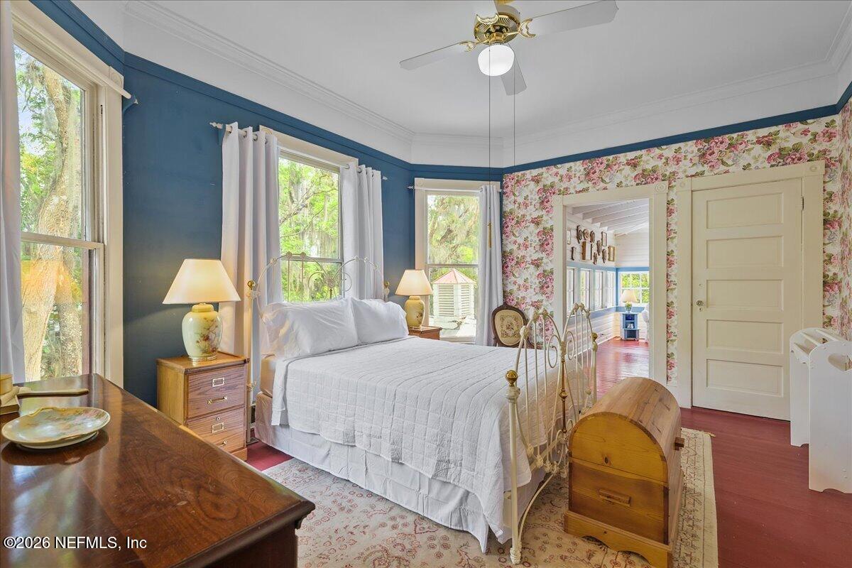 223 Madison Street Palatka, FL 32177 - Photo 28 of 60 a bedroom with a bed and wooden floor