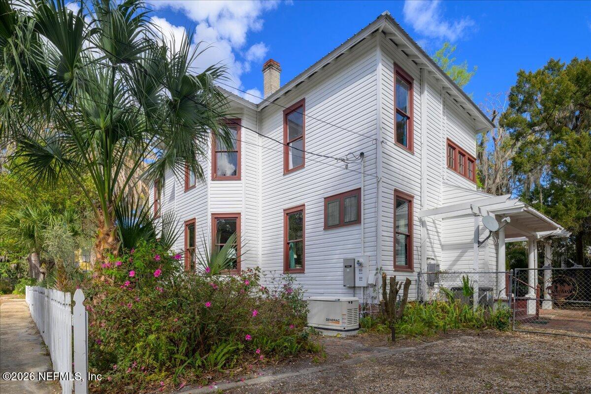 223 Madison Street Palatka, FL 32177 - Photo 41 of 60 a view of a white house with a large window and potted plants