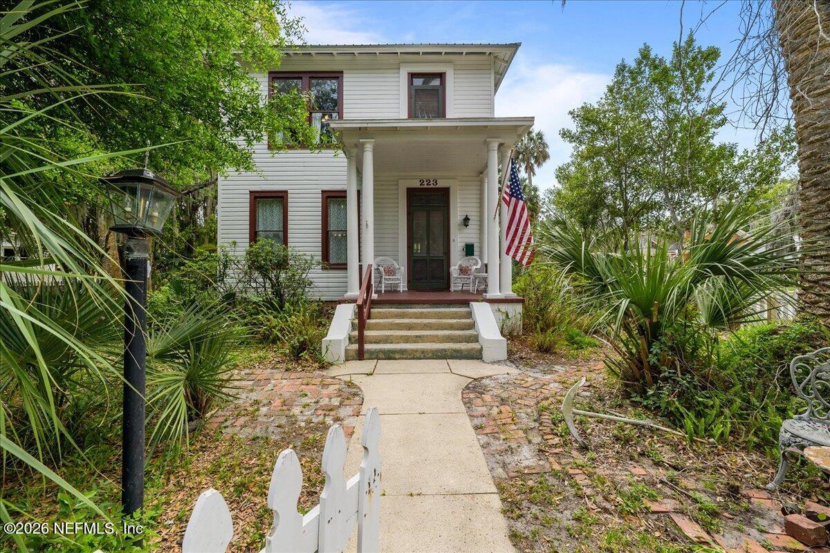 223 Madison Street Palatka, FL 32177 - Photo 43 of 60 a view of a house with potted plants and a tree