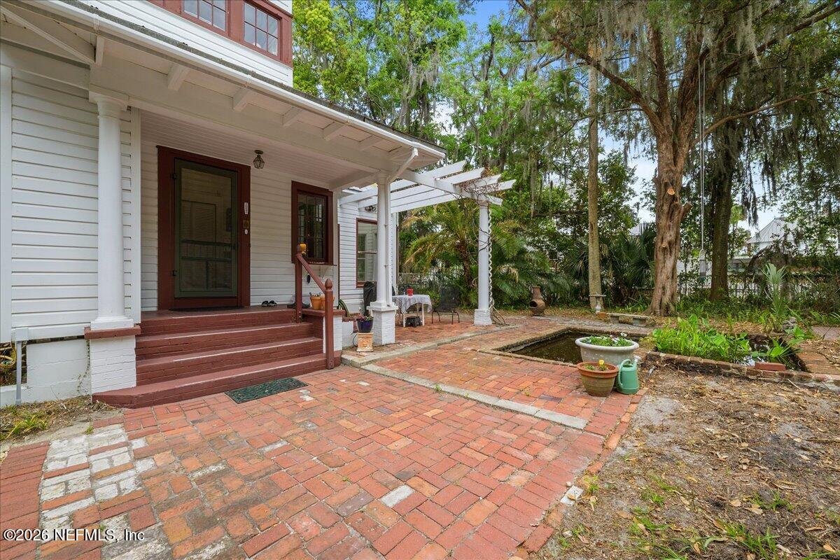 223 Madison Street Palatka, FL 32177 - Photo 49 of 60 a view of a patio with table and chairs with wooden fence and plants