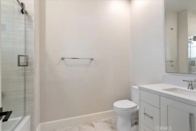 a white toilet sitting next to a bathroom sink