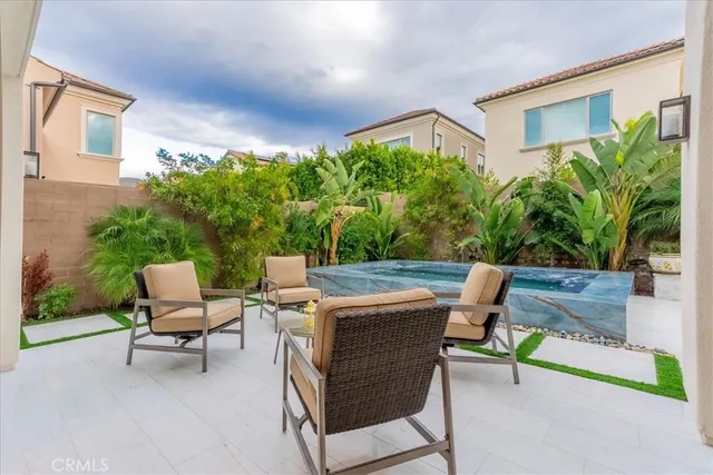 a backyard of a house with table and chairs