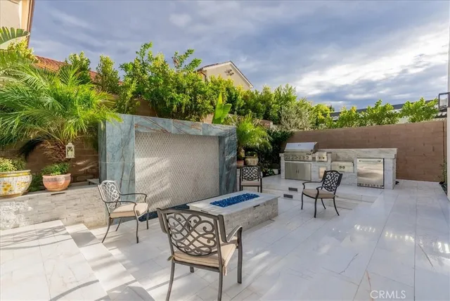 a view of a patio with table and chairs and potted plants