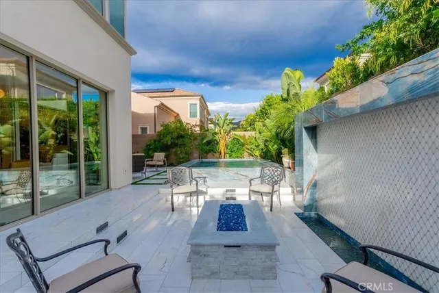 a view of a patio with couches table and chairs and potted plants
