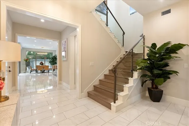 a view of entryway and hall with wooden floor