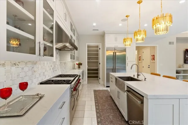 a kitchen with a sink a stove and cabinets