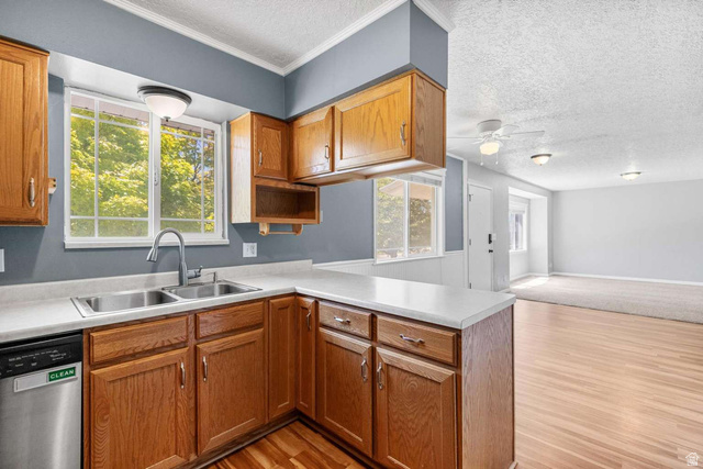 415 East 1150th Street North Logan, UT 84341 - Photo 10 of 38 Kitchen featuring wood cabinetry, a double basin stainless steel sink, a stainless steel dishwasher, and white countertops