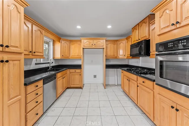 a kitchen with granite countertop a sink and cabinets