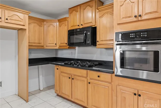 a view of a kitchen with a sink and a stove top oven
