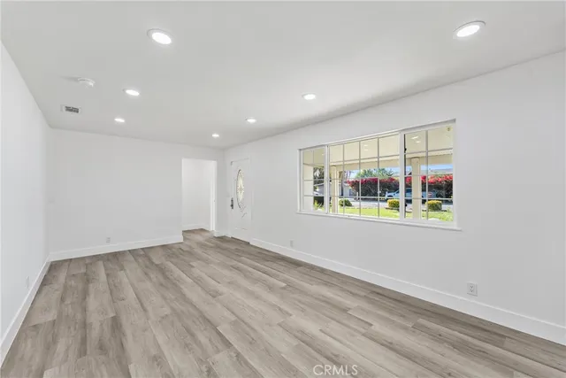 a large kitchen with stainless steel appliances granite countertop a stove a sink and a microwave