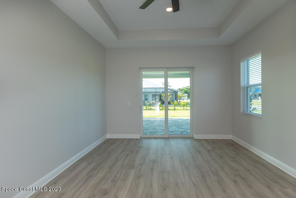 3940 Domain Court Melbourne, FL 32934 - Photo 17 of 27 an empty room with wooden floor and windows