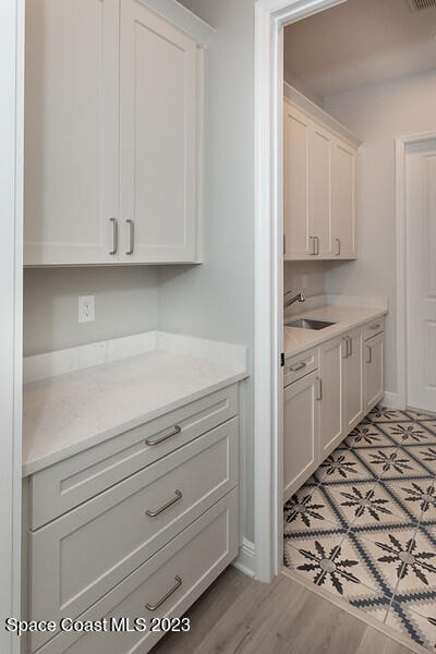 3940 Domain Court Melbourne, FL 32934 - Photo 19 of 27 a kitchen with a stove and cabinets
