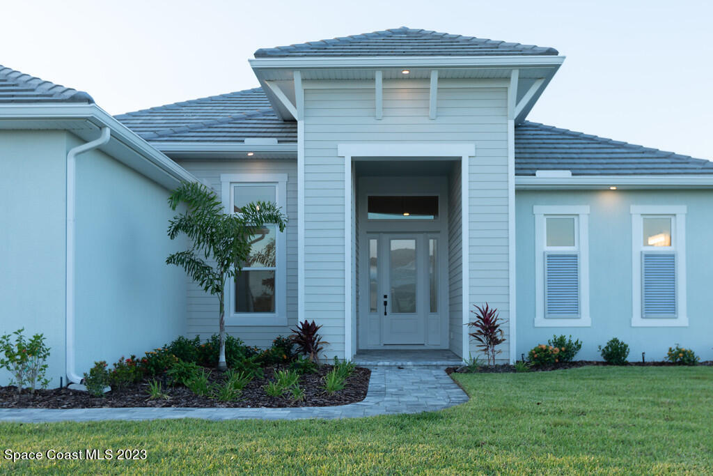 3940 Domain Court Melbourne, FL 32934 - Photo 2 of 27 a front view of a house with a yard