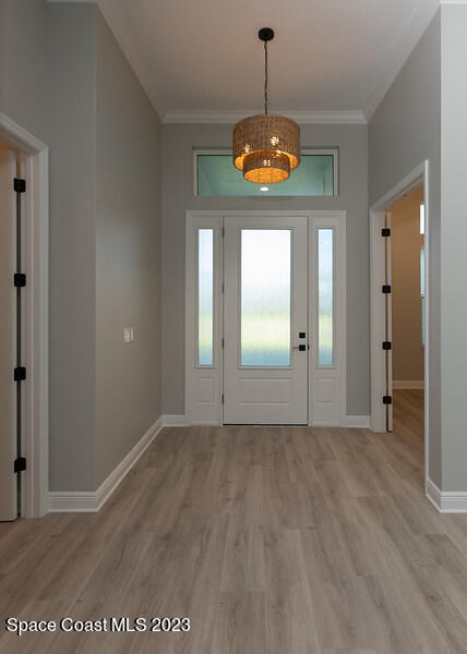 3940 Domain Court Melbourne, FL 32934 - Photo 3 of 27 wooden floor in an empty room with a window