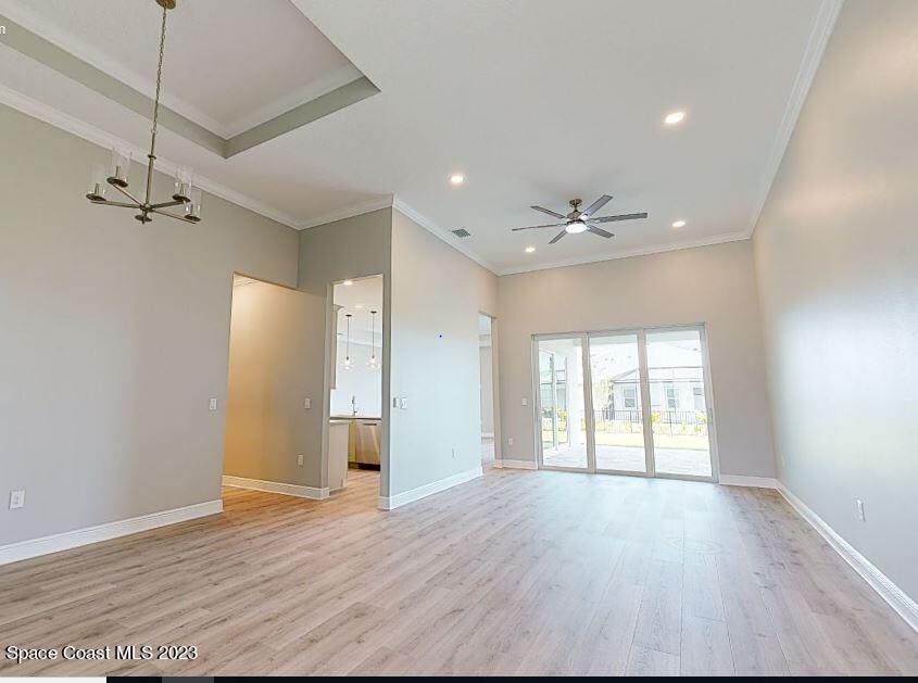 3940 Domain Court Melbourne, FL 32934 - Photo 4 of 27 a view of an empty room with a window and wooden floor