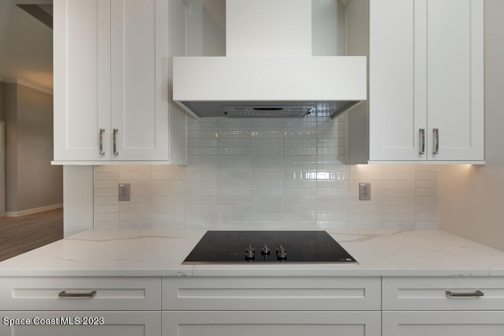 3940 Domain Court Melbourne, FL 32934 - Photo 7 of 27 a kitchen with white cabinets and sink