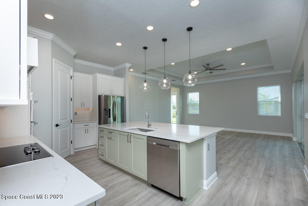 3940 Domain Court Melbourne, FL 32934 - Photo 8 of 27 a large kitchen with kitchen island a sink stainless steel appliances and cabinets