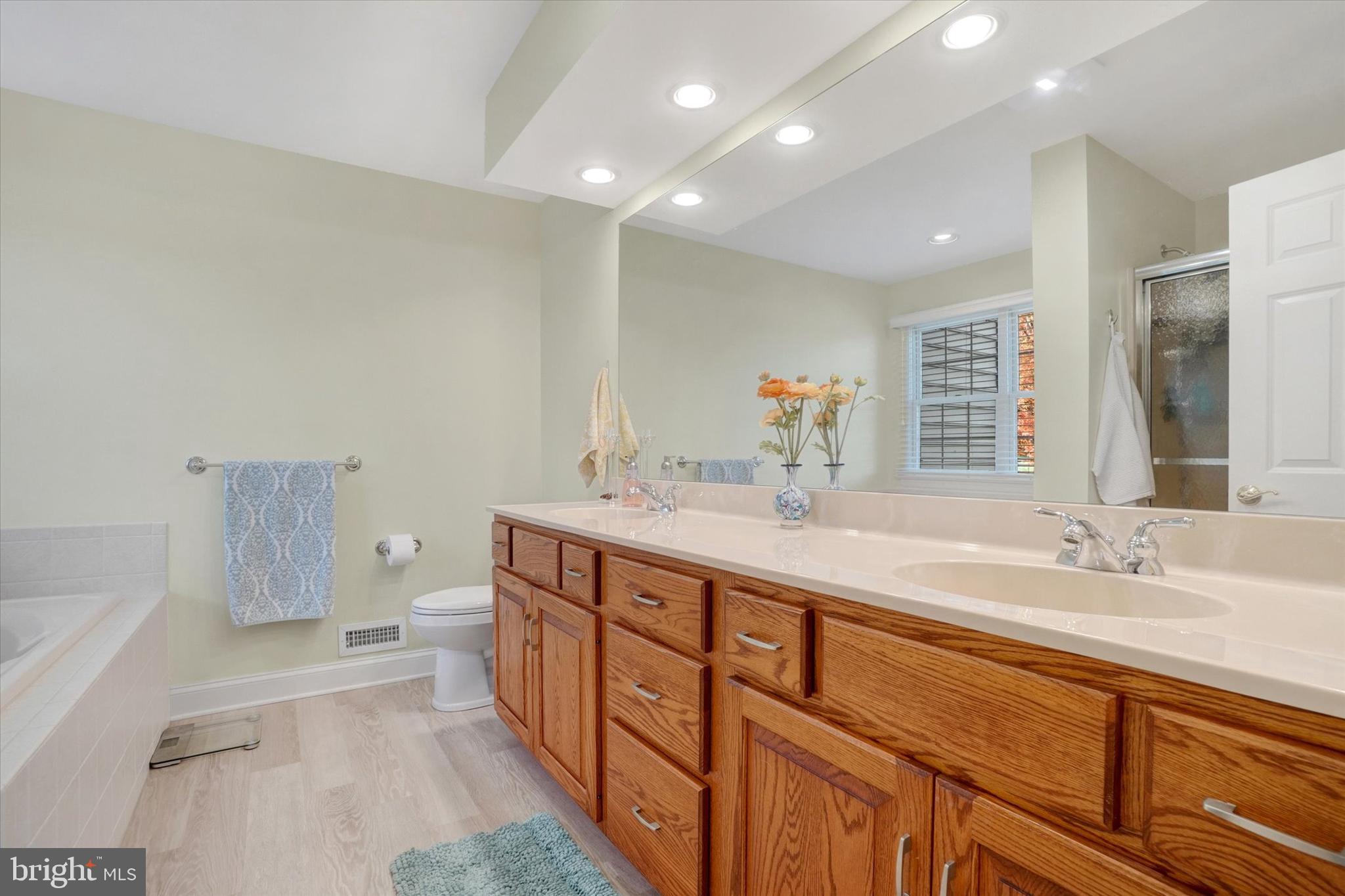 657 Campbell Road York, PA 17402 - Photo 13 of 30 a spacious bathroom with a double vanity sink a mirror and a bathtub