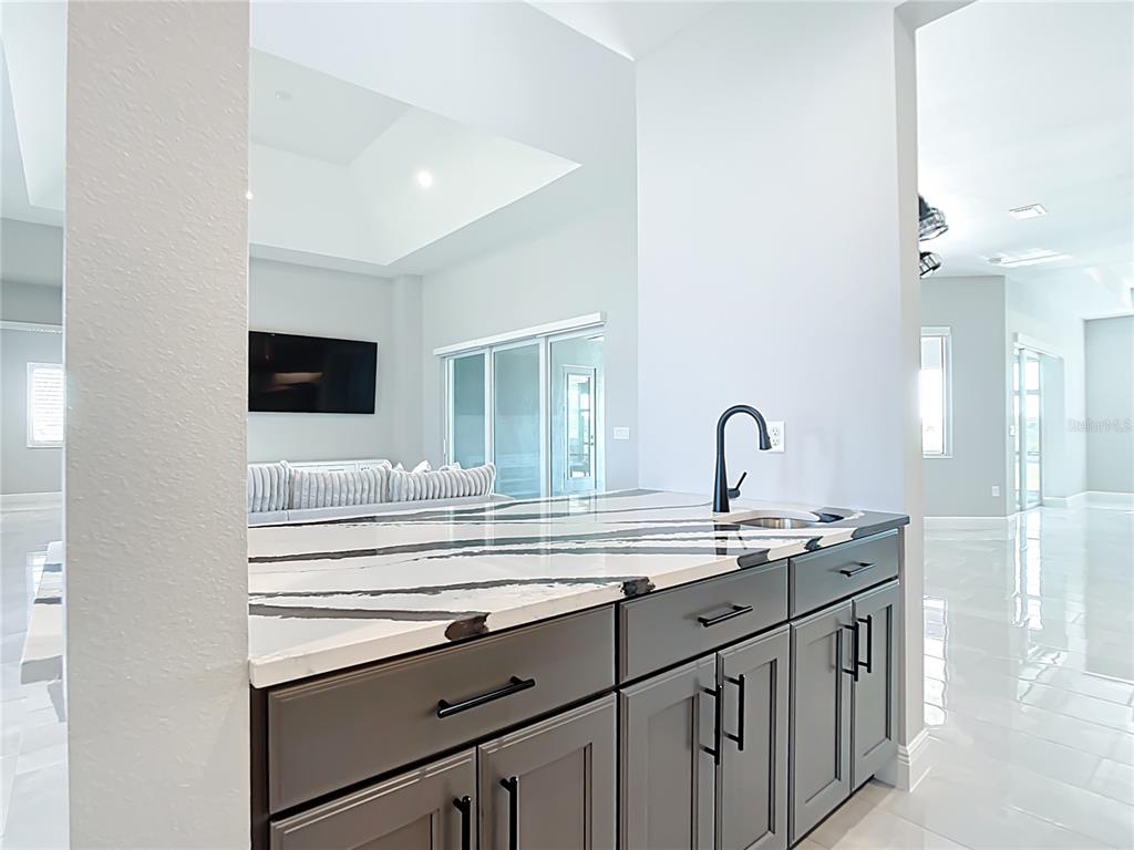 3586 Recurve Circle Sarasota, FL 34240 - Photo 13 of 65 a kitchen with a sink and a refrigerator