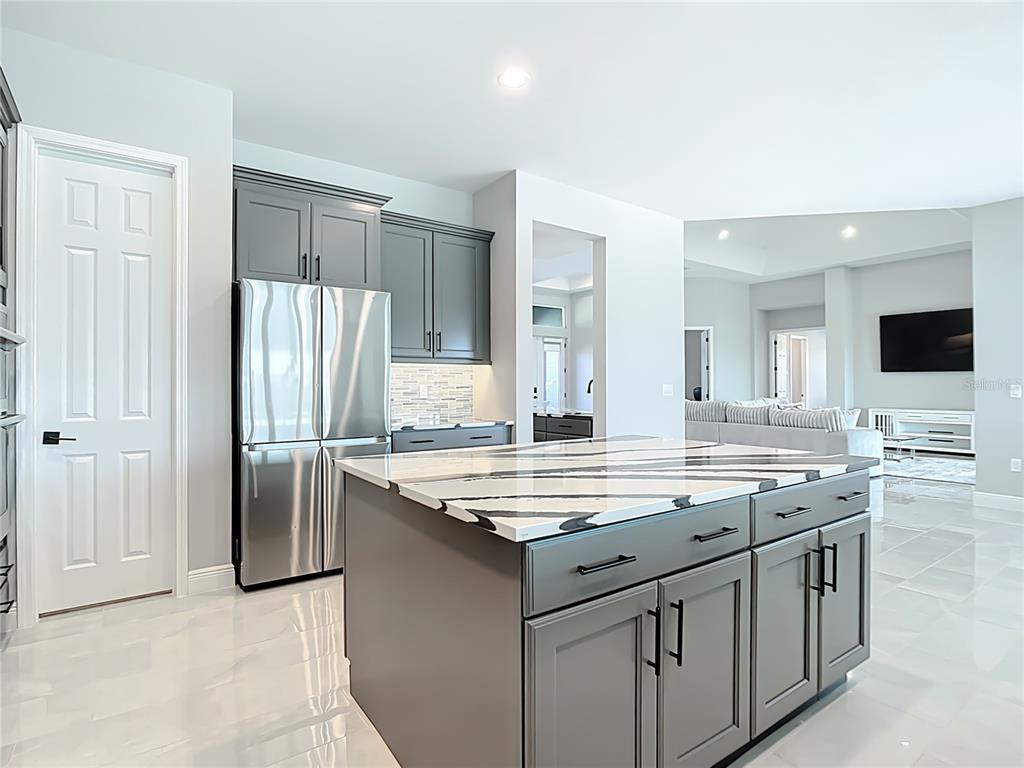 3586 Recurve Circle Sarasota, FL 34240 - Photo 14 of 66 a kitchen with stainless steel appliances granite countertop a sink and a refrigerator