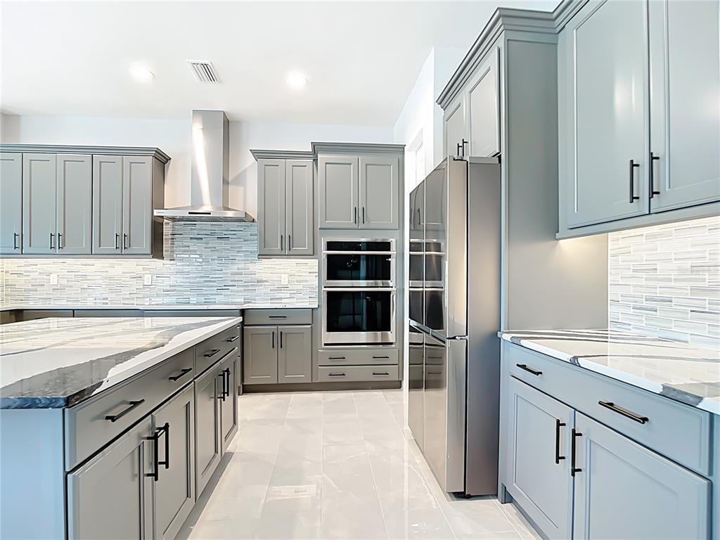 3586 Recurve Circle Sarasota, FL 34240 - Photo 16 of 66 a kitchen with stainless steel appliances granite countertop a refrigerator and a sink