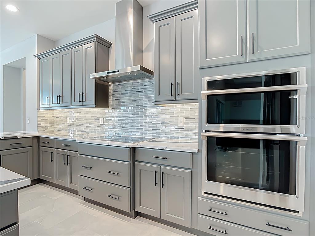 3586 Recurve Circle Sarasota, FL 34240 - Photo 17 of 66 a kitchen with stainless steel appliances granite countertop white cabinets and a stove