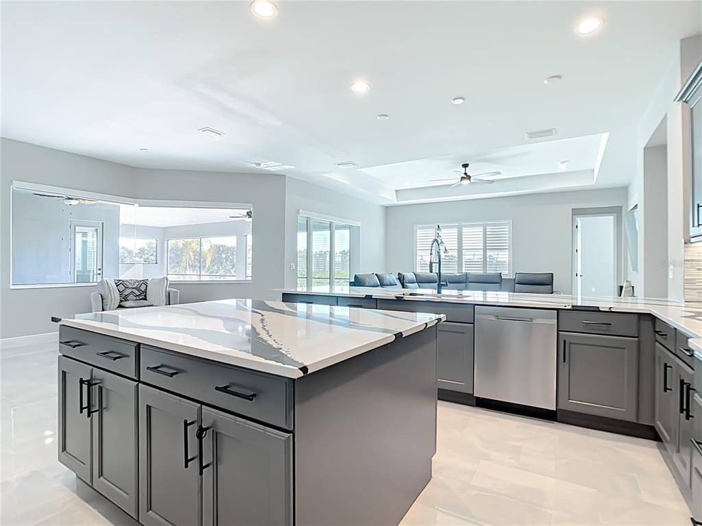 3586 Recurve Circle Sarasota, FL 34240 - Photo 18 of 66 a kitchen with counter top space sink and center island