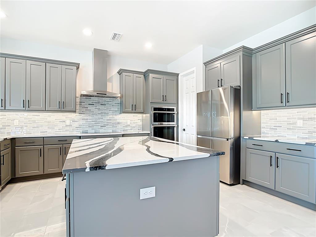 3586 Recurve Circle Sarasota, FL 34240 - Photo 19 of 66 a kitchen with stainless steel appliances granite countertop a refrigerator sink and cabinets