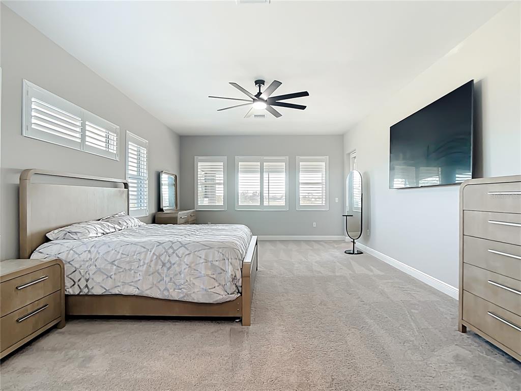 3586 Recurve Circle Sarasota, FL 34240 - Photo 24 of 65 a spacious bedroom with a bed and a flat screen tv