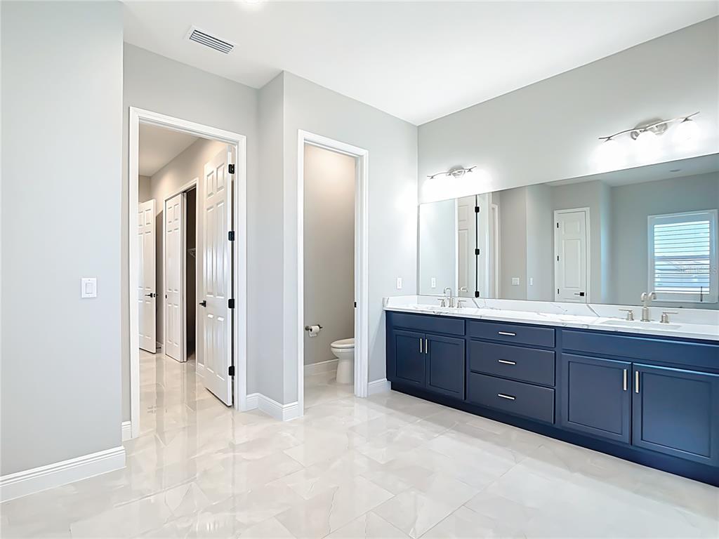 3586 Recurve Circle Sarasota, FL 34240 - Photo 28 of 65 a bathroom with a tub sink shower and mirror