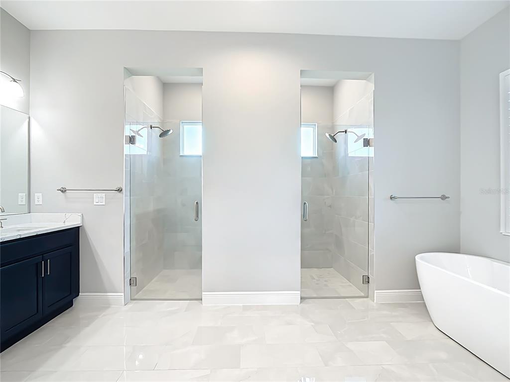3586 Recurve Circle Sarasota, FL 34240 - Photo 29 of 65 a bathroom with a bathtub and a shower