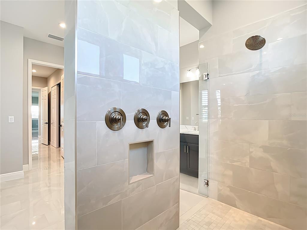 3586 Recurve Circle Sarasota, FL 34240 - Photo 30 of 65 a bathroom with a shower and a mirror