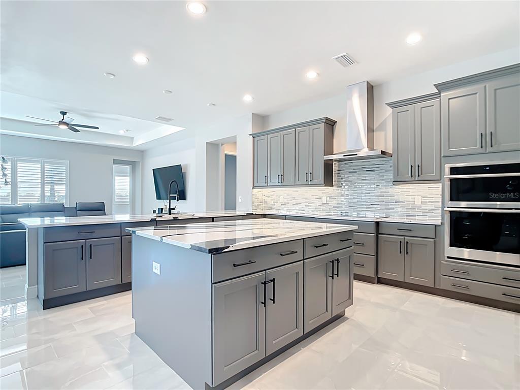 3586 Recurve Circle Sarasota, FL 34240 - Photo 4 of 66 a kitchen with stainless steel appliances granite countertop a stove top oven sink and cabinets