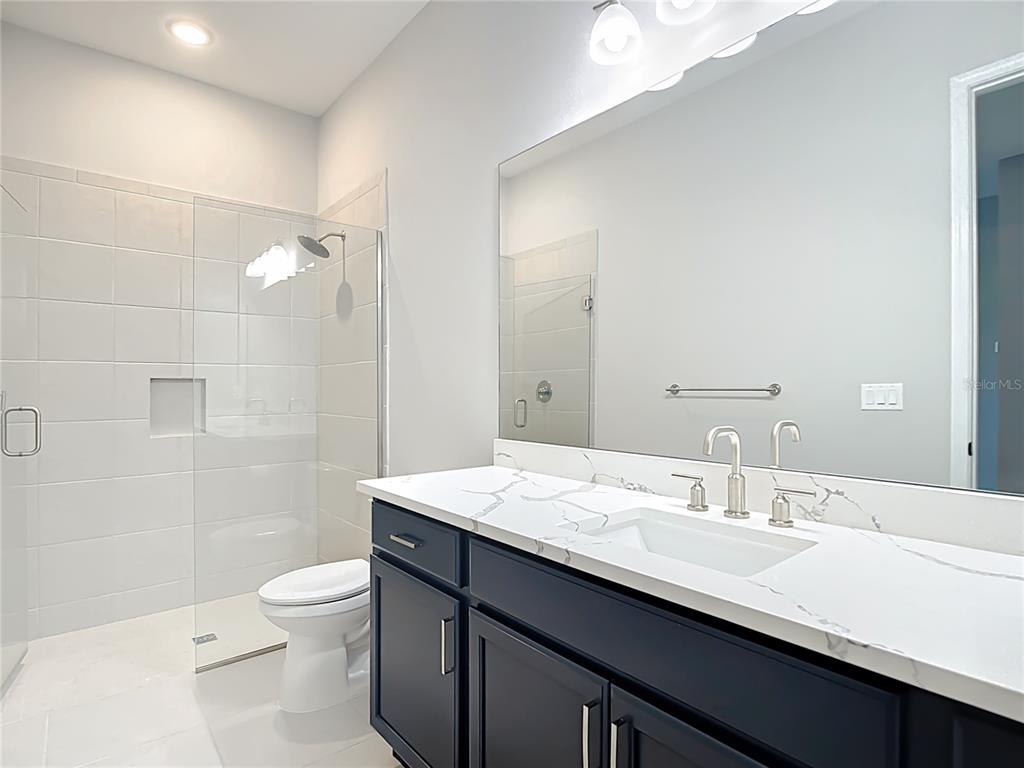 3586 Recurve Circle Sarasota, FL 34240 - Photo 42 of 66 a bathroom with a sink a toilet a shower and a mirror