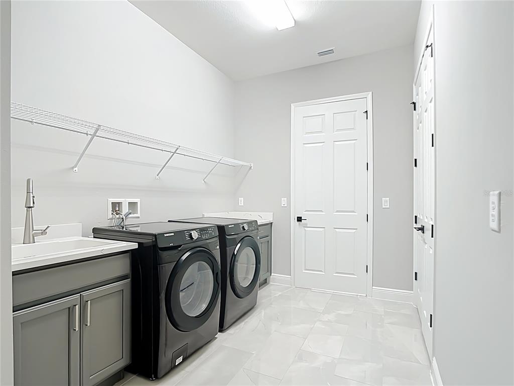 3586 Recurve Circle Sarasota, FL 34240 - Photo 45 of 65 a utility room with sink dryer and washer